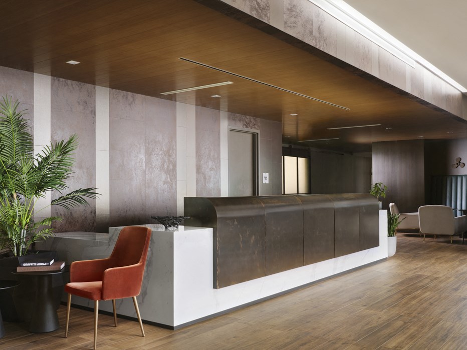 a lobby with a reception desk and chairs