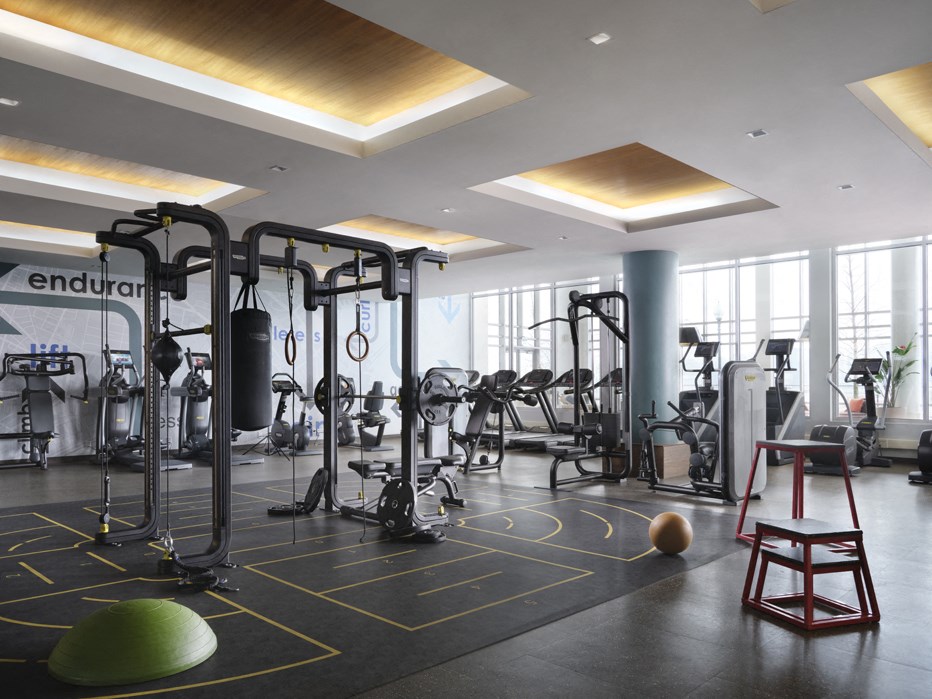 a gym with weights machines and other exercise equipment in a large room