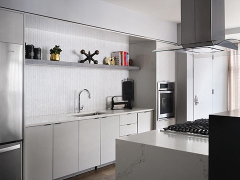 a kitchen with white cabinets and a counter top