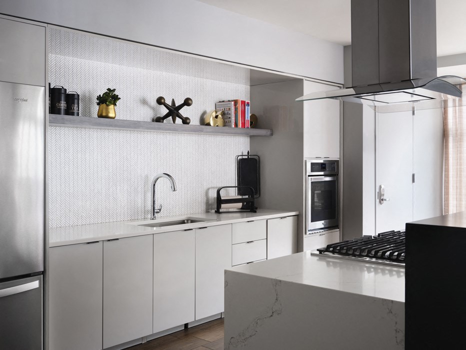 a kitchen with white cabinets and a counter top