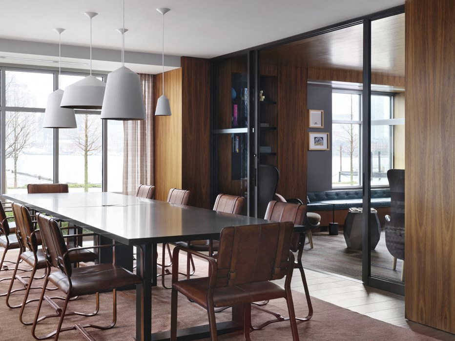 a dining room with a black table and chairs