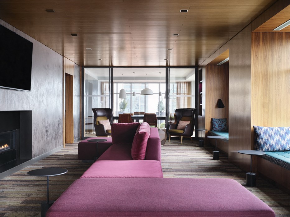 a living room with a pink couch and a fireplace