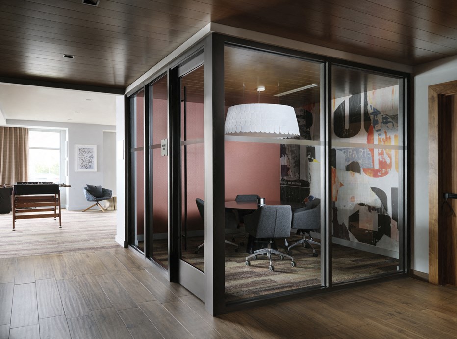 a conference room with glass walls and a table and chairs
