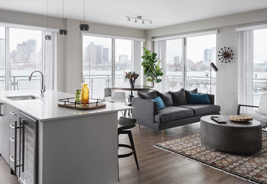 a living room and kitchen with a view of the city