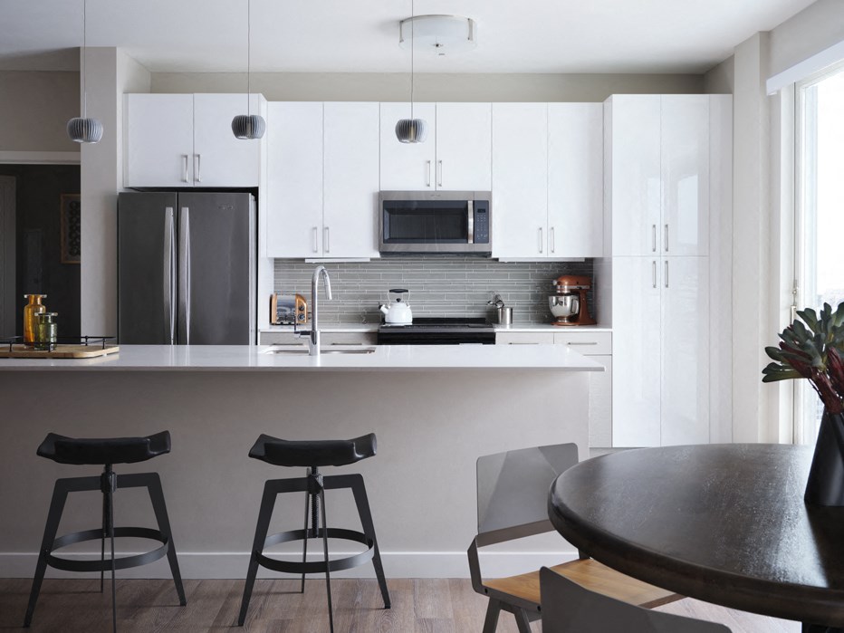 a kitchen with white cabinets and a counter top