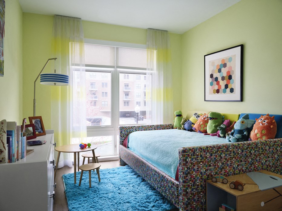 a bedroom with a bed and a blue rug