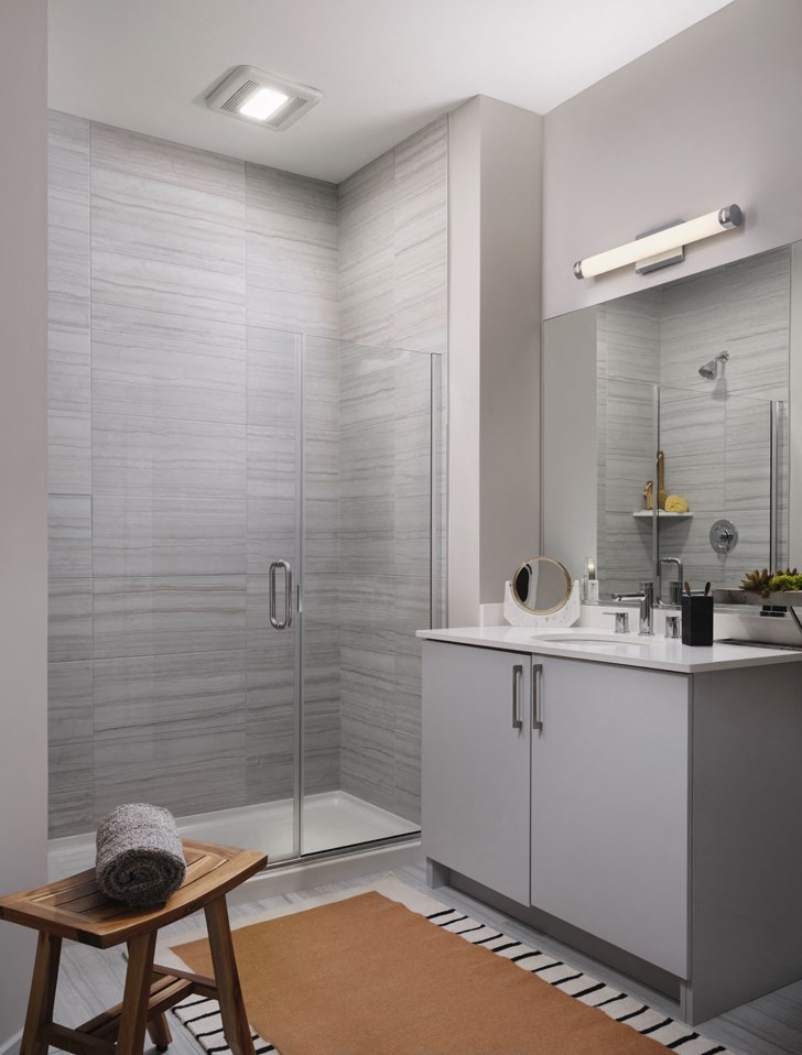 a bathroom with a shower and a sink and a mirror