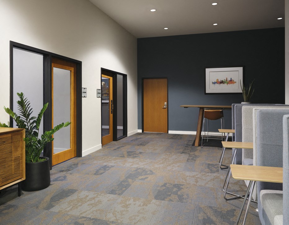 an empty room with a table and chairs and doors