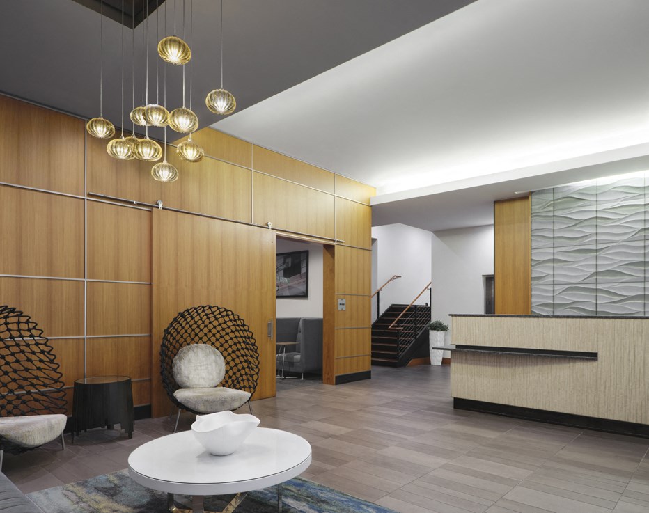 a lobby with a white table and chairs and a staircase