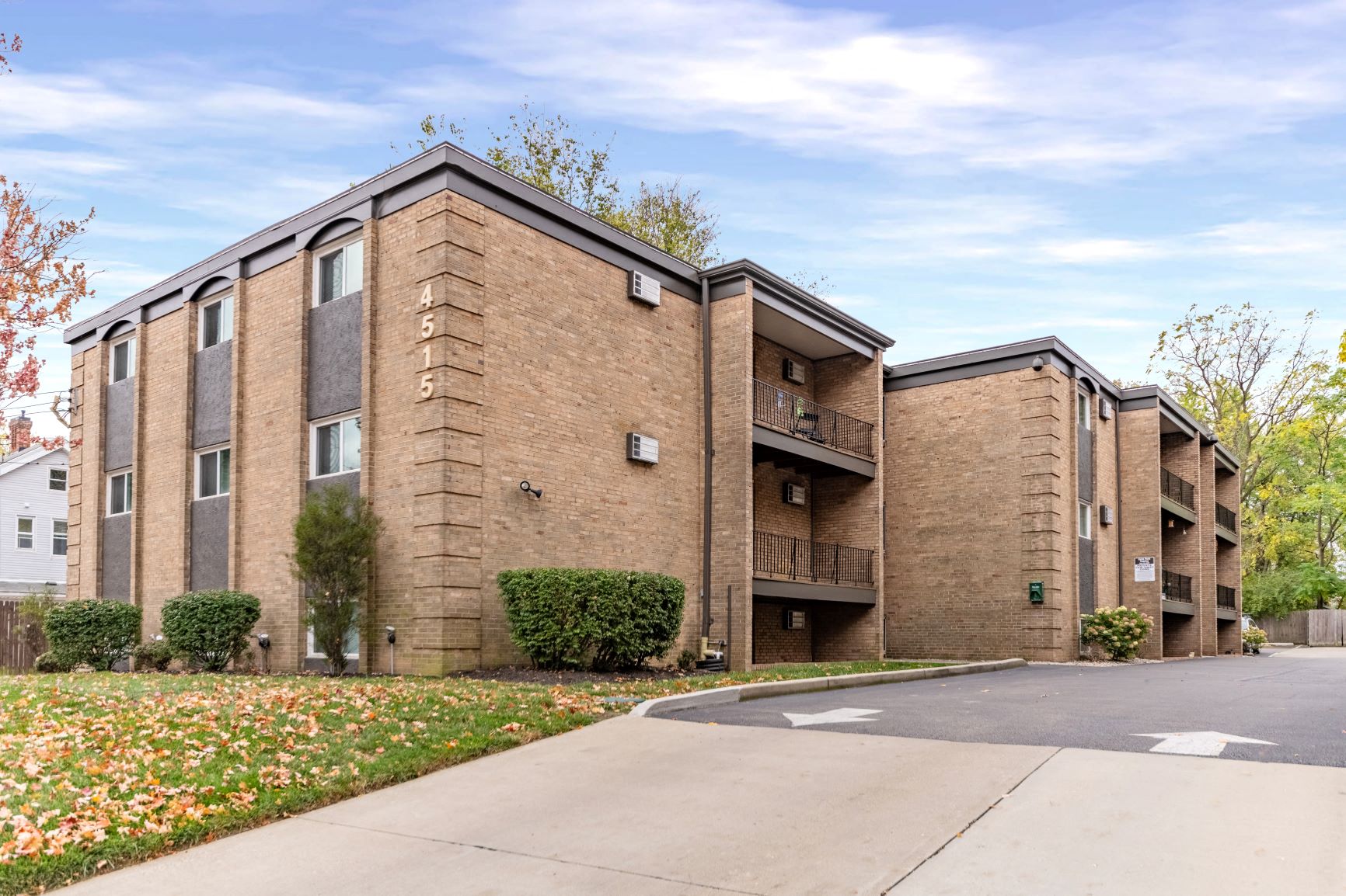 Apartment building with a driveway in front.