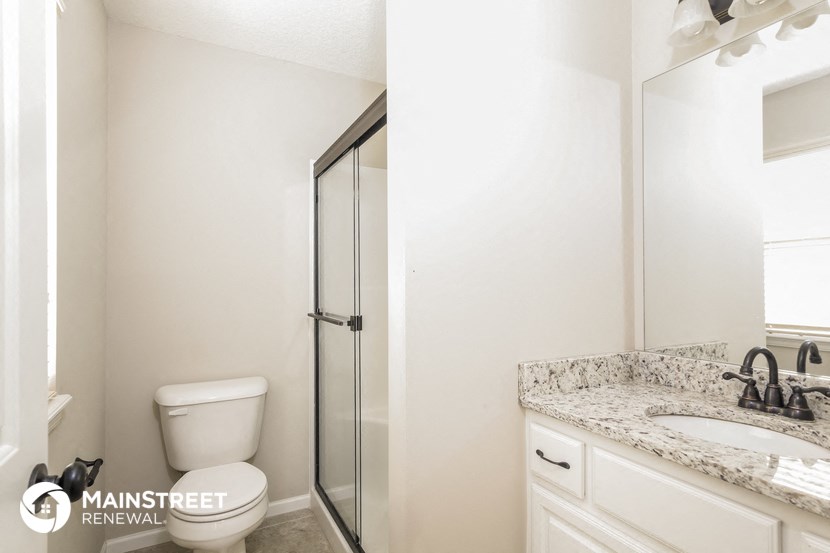 an image of a bathroom with a toilet sink and shower