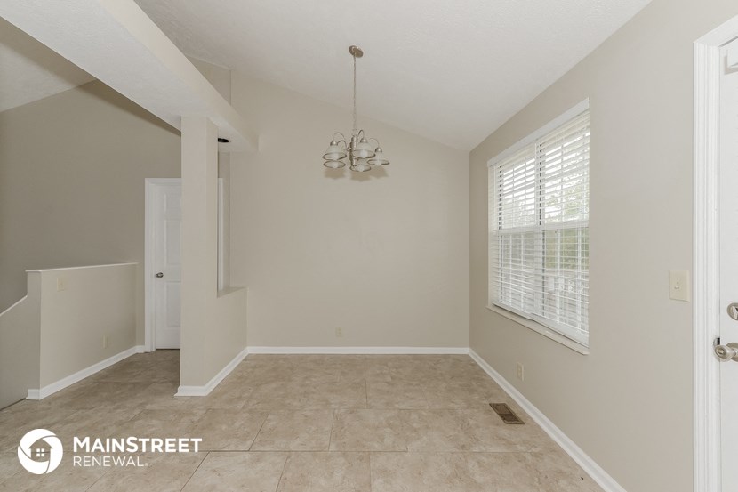 an empty living room with a large window