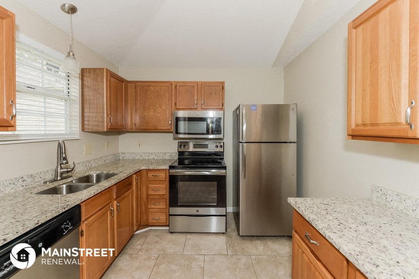 a kitchen with granite counter tops and stainless steel appliances