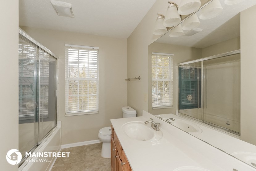 a bathroom with a sink and a mirror and a shower