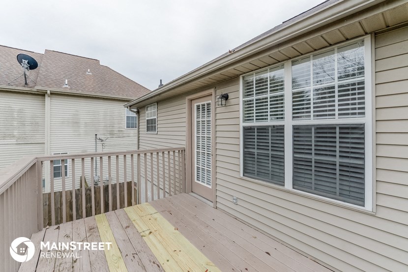 the deck off of the master bedroom has a view of the neighboring houses