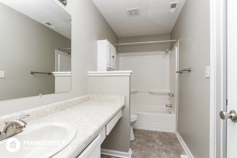 a bathroom with a sink and a shower and a toilet