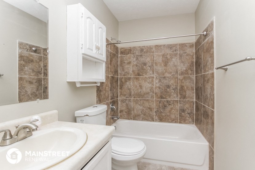 a bathroom with a sink toilet and a bath tub
