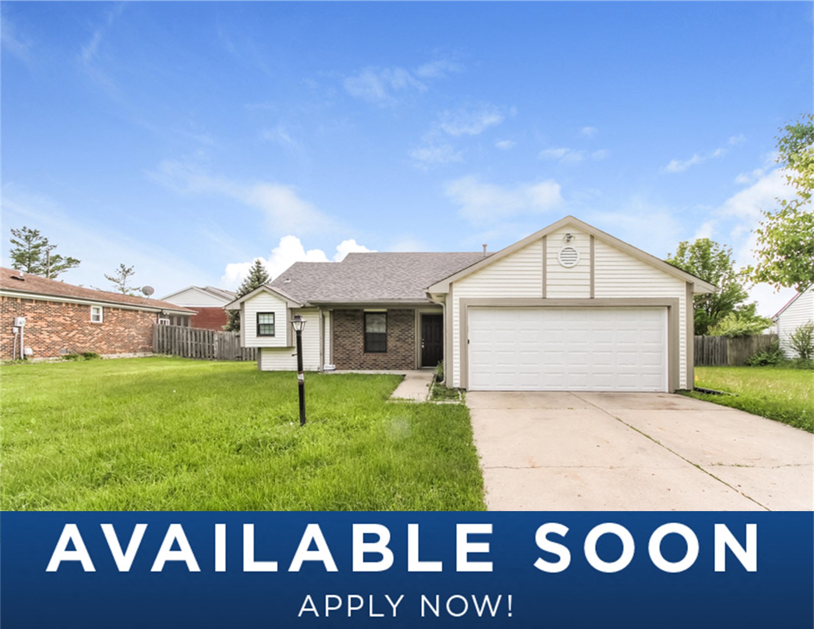 a suburban home with a lawn and a driveway