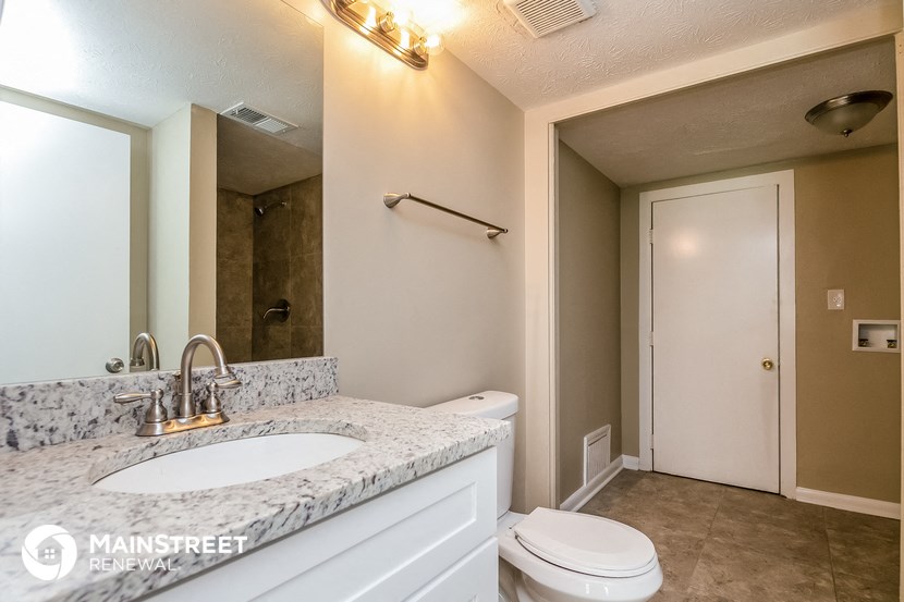 a bathroom with a sink and a toilet and a mirror