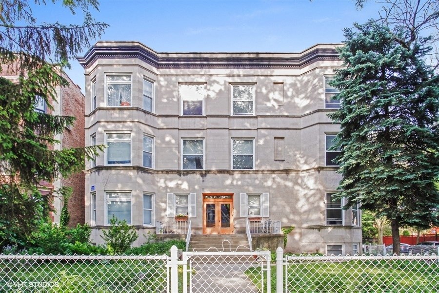 a large house with a fence in front of it