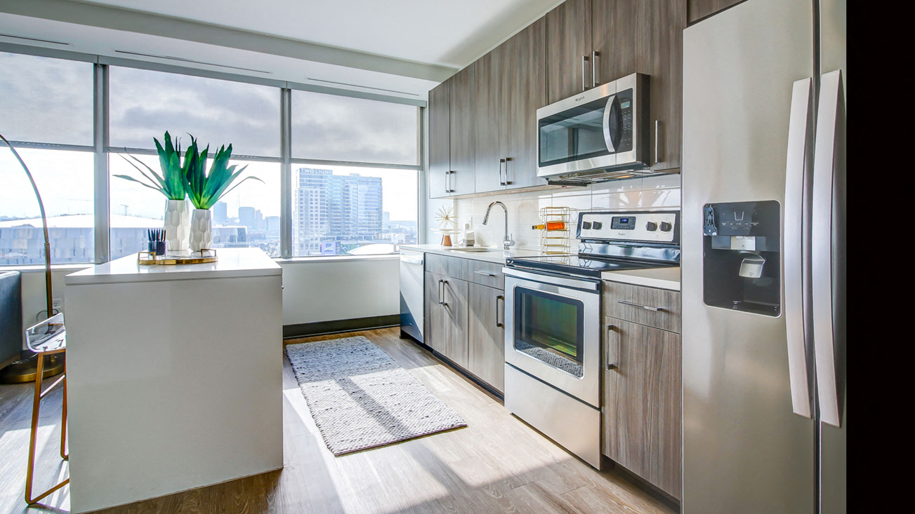 Kitchen With Full Set Of Stainless Appliances And Wood-Style Flooring  at The Grand, Kansas City