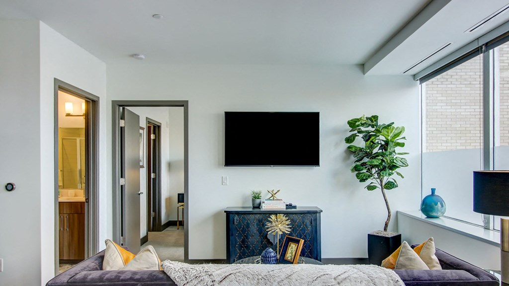 Living room area with tv at The Grand, Missouri, 64106
