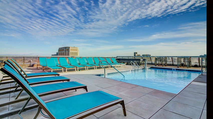 Kansas City MO Apartments for Rent-The Grand Apartments Rooftop Pool With Lounge Chairs And 360 View Of City - Photo Gallery 1