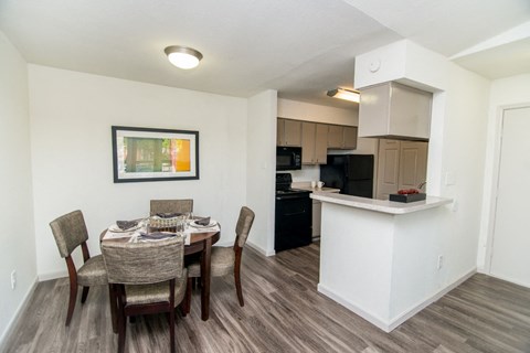 a dining room and kitchen with a table and chairs