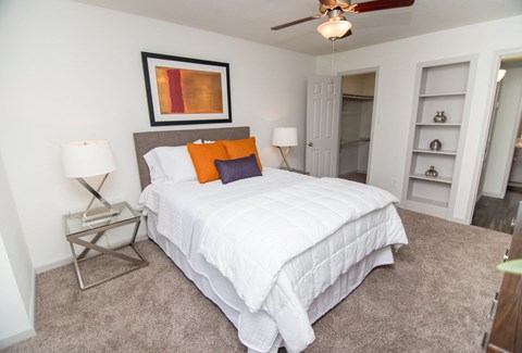 View of bedroom showing built-in shelving and walk-in closet.