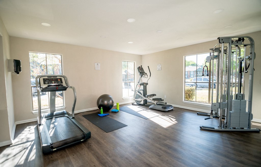 Fitness center with treadmill and other gym equipment.