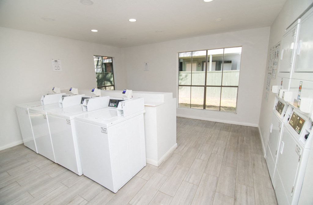 Clothing care center showing washing machines and dryers.