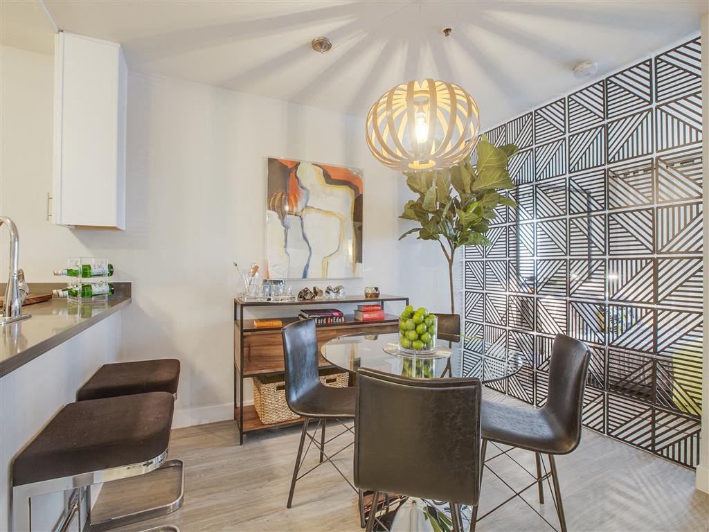 a dining room with a table and chairs and a kitchen