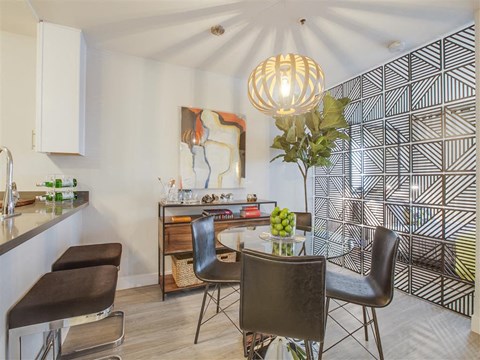 a dining room with a table and chairs and a kitchen