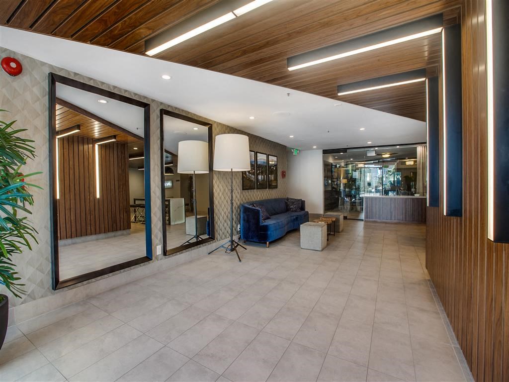 the lobby or reception area of a hotel with a blue couch