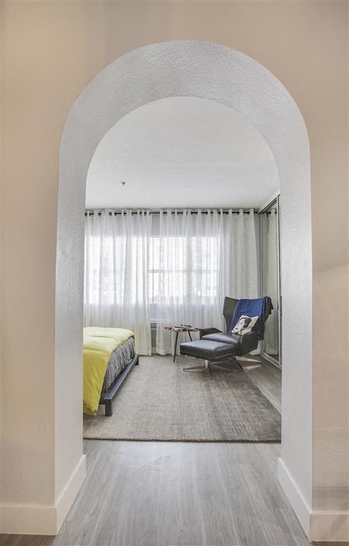 a living room with a bed and a chair