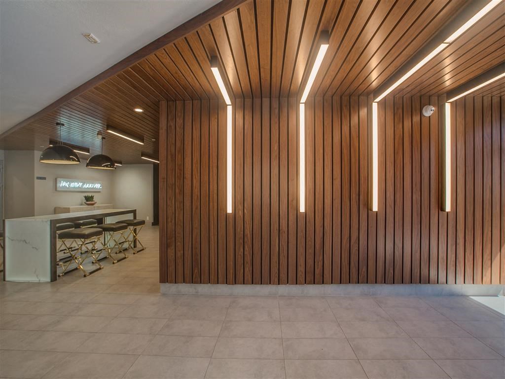 a large room with a kitchen and a table and chairs