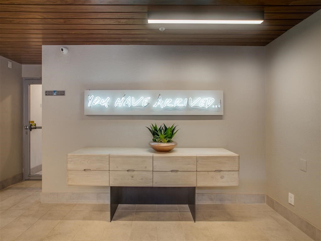 a desk in a room with a sign on the wall