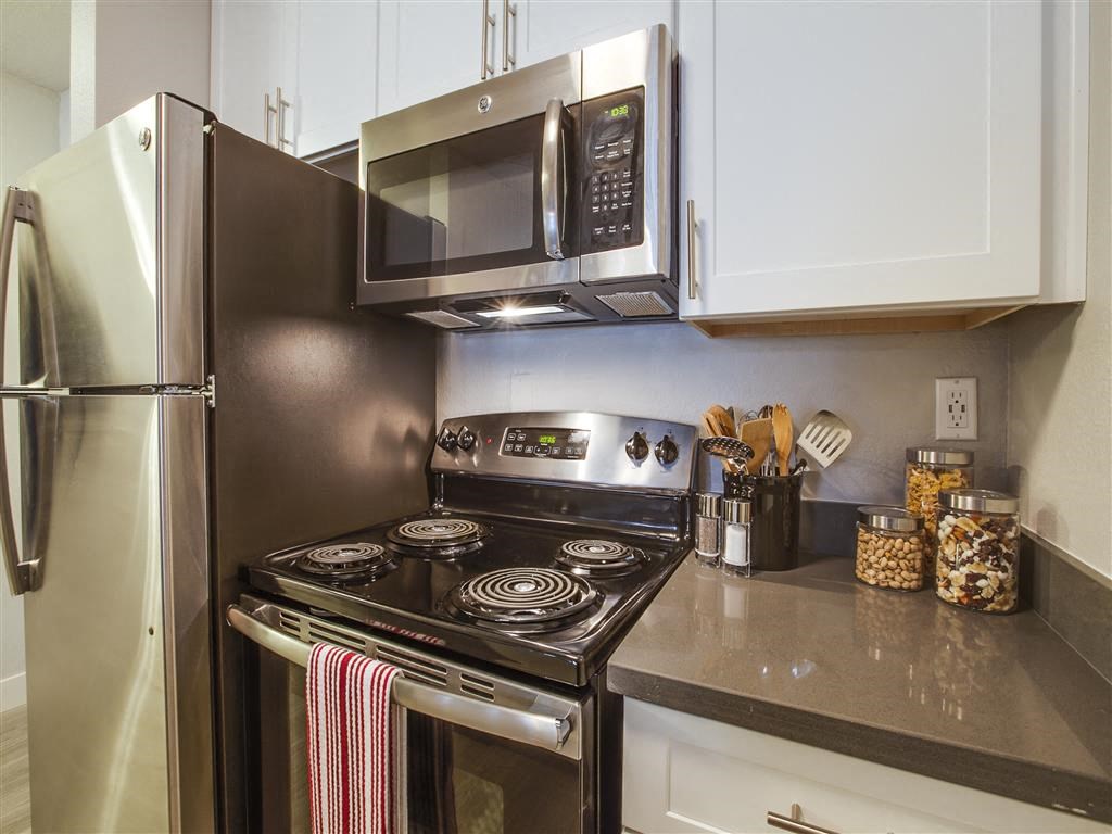 a kitchen with stainless steel appliances and a microwave