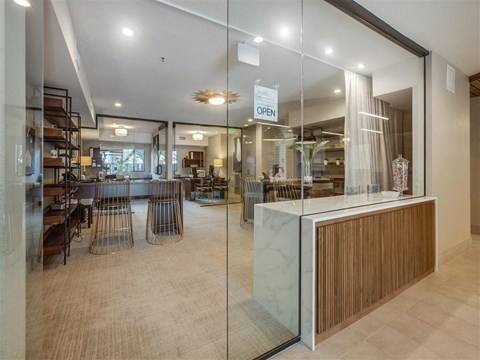 the lobby of a restaurant with a counter and glass doors