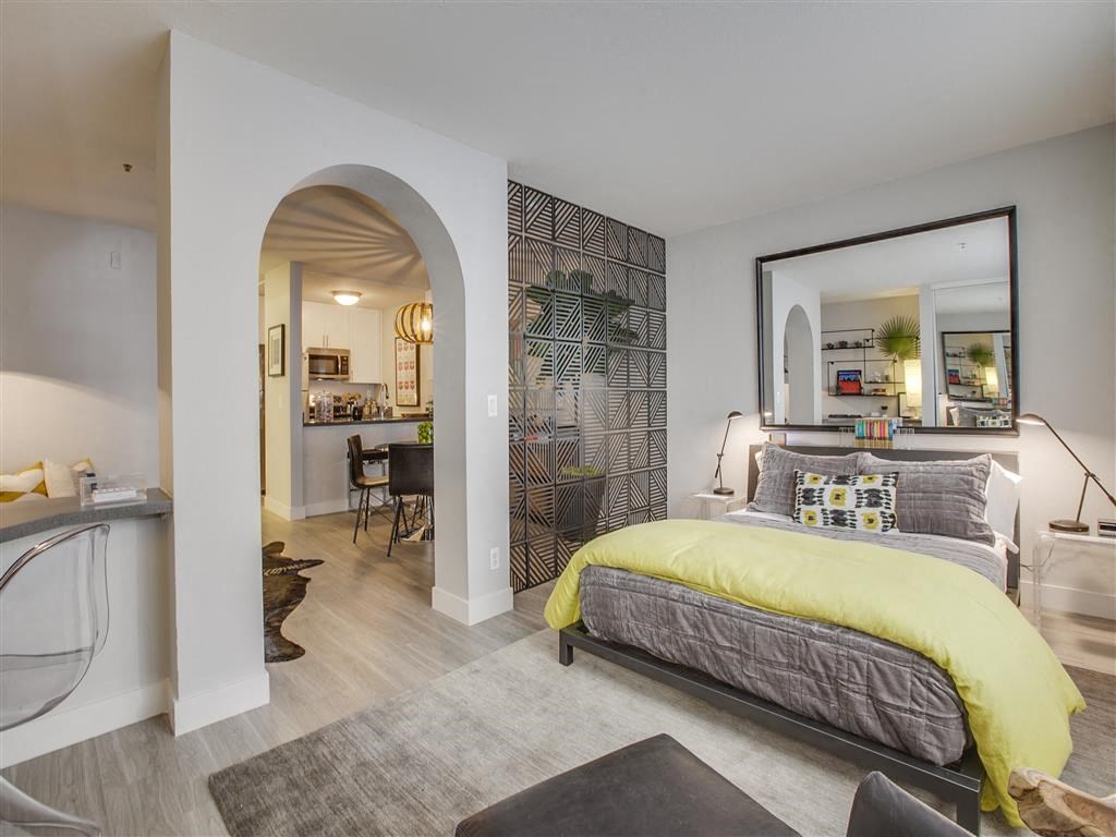 a bedroom with a large mirror and a bed