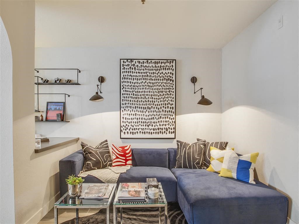 a living room with a blue couch and a table