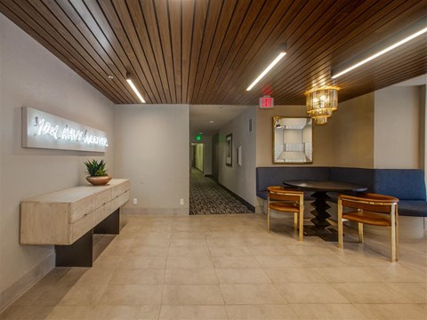 the lobby of a restaurant with a table and chairs