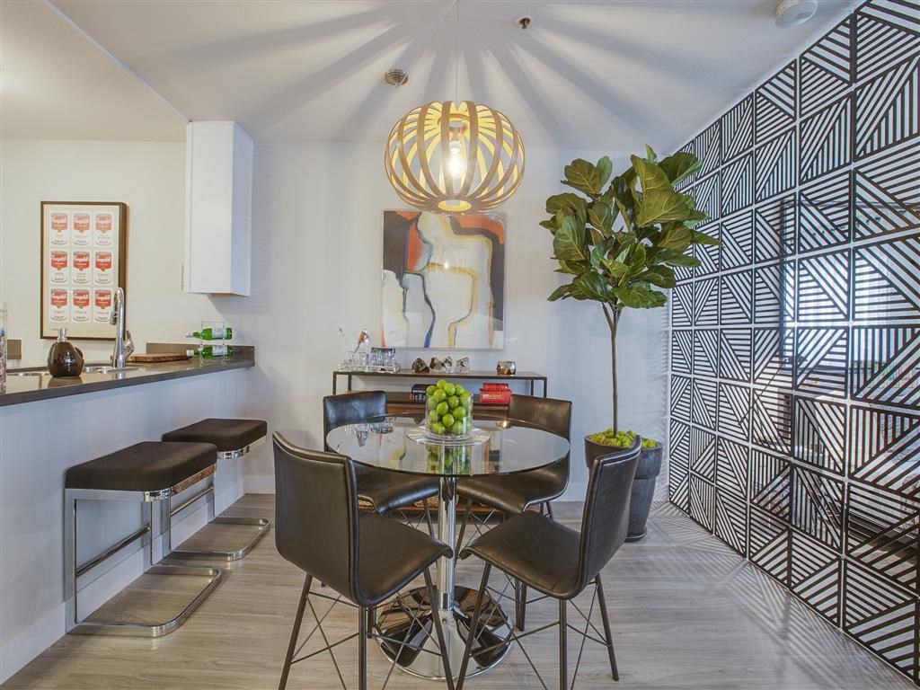 a dining room with a table and chairs and a kitchen