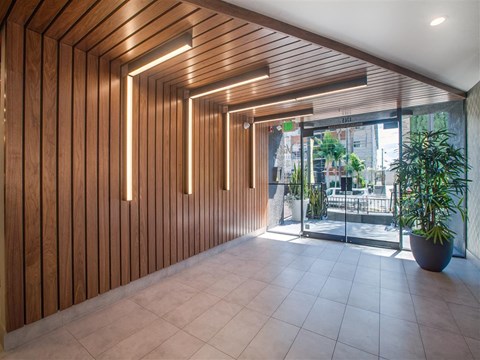 the lobby or reception area of an office building with a plant
