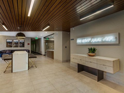 a lobby with a reception desk and a table
