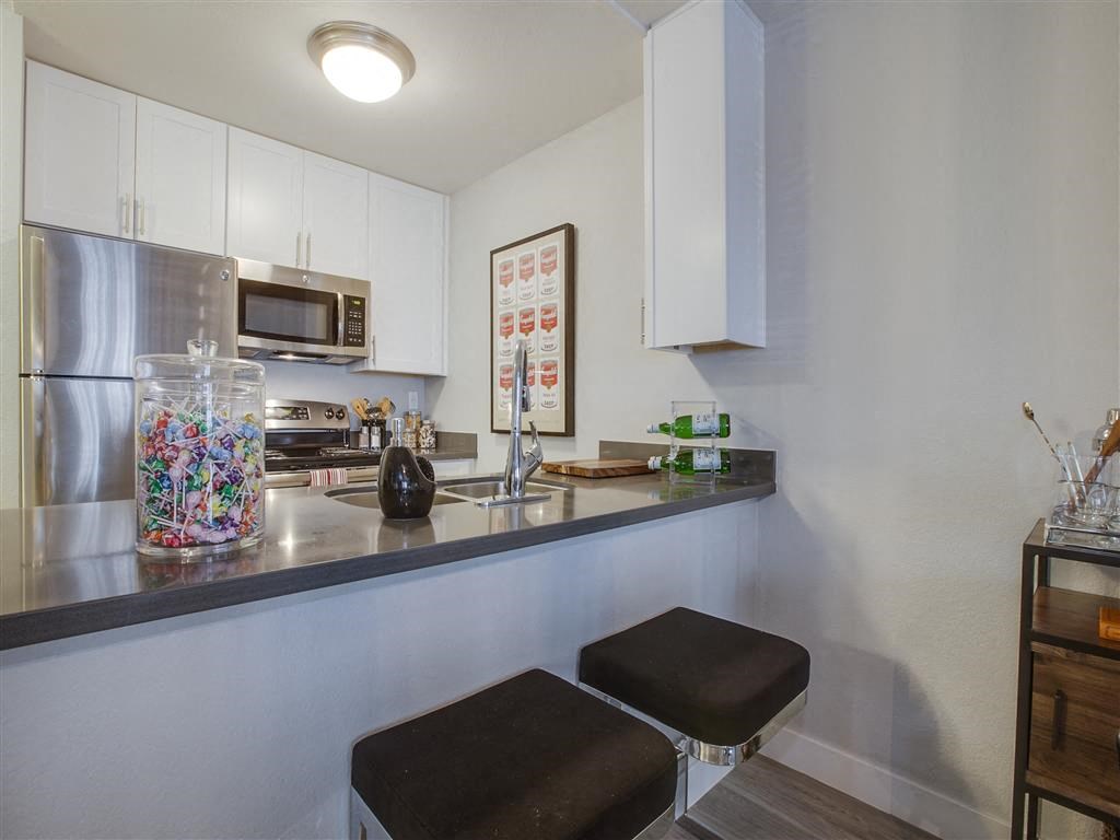 a kitchen with a counter top and a refrigerator