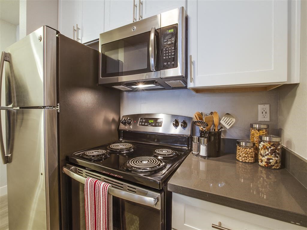 a kitchen with stainless steel appliances and a microwave