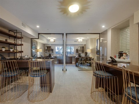 the lobby or reception area of a hotel with tables and chairs