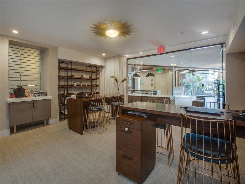 a bar with a counter and chairs in a lobby