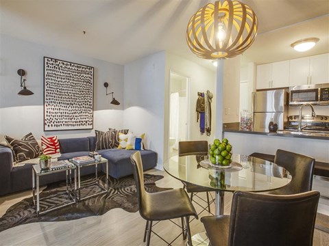a living room with a glass table and a couch